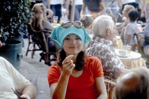 jackie bouvier kennedy onassis at a cafe with headscarf and glasses.jpg